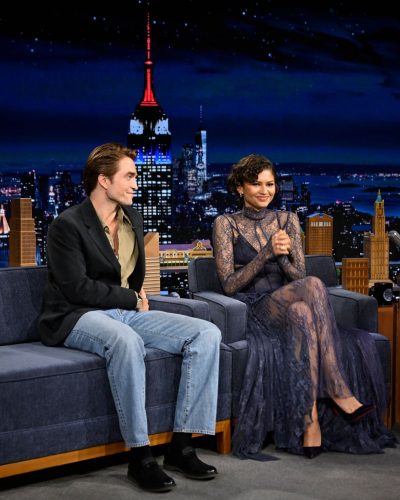 Zendaya styled in a navy sheer dress with flowing layers