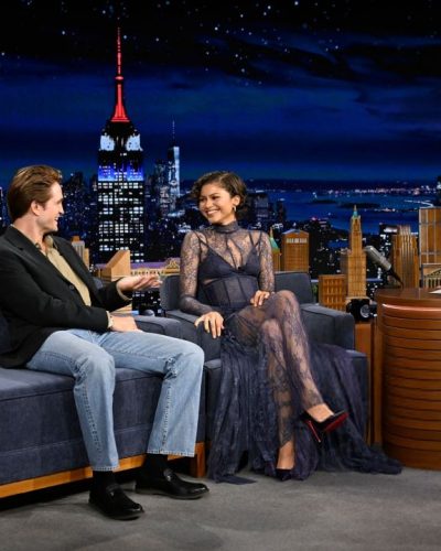 Zendaya in a flowing navy gown with intricate lace accents