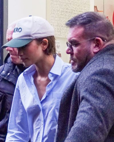 Zendaya sporting a blue shirt with relaxed denim pants.