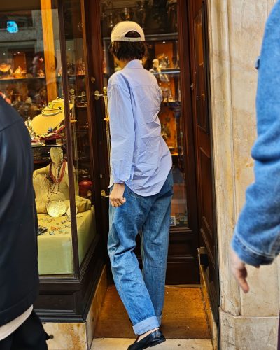 Zendaya with a blue shirt paired with stylish black flats.