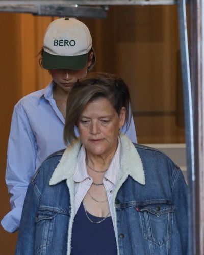 Zendaya sporting a blue shirt with chic denim bottoms.