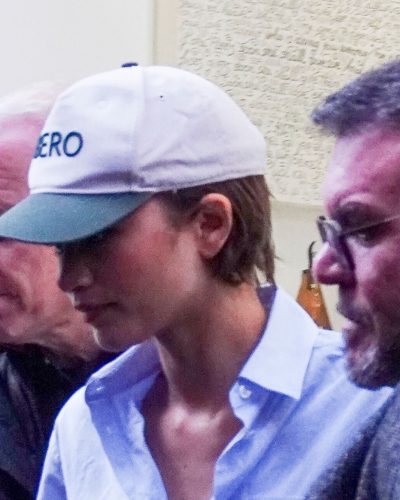 Zendaya in a light blue button-up shirt and black shoes.