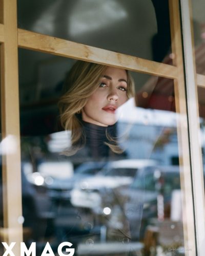 Zibby Allen dressed in black blazer and stylish lace stockings.