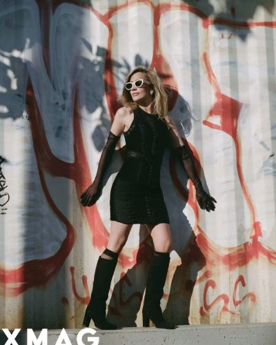 Zibby Allen wearing tailored black blazer and satin scarf.