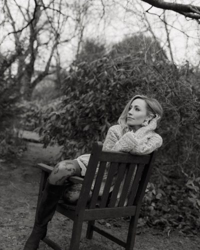 Zibby Allen in fitted black blazer and stylish shorts.