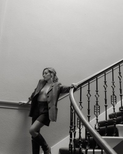 Zibby Allen in black tailored blazer and shorts.